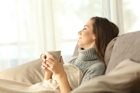 Woman relaxing with a cup of coffee or tea