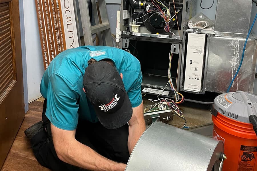 Technician performing furnace maintenance in Manasquan NJ