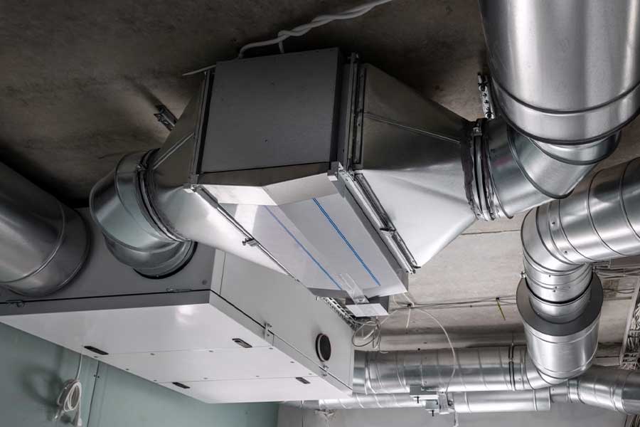 Heat recovery ventilator installed with ductwork in a building